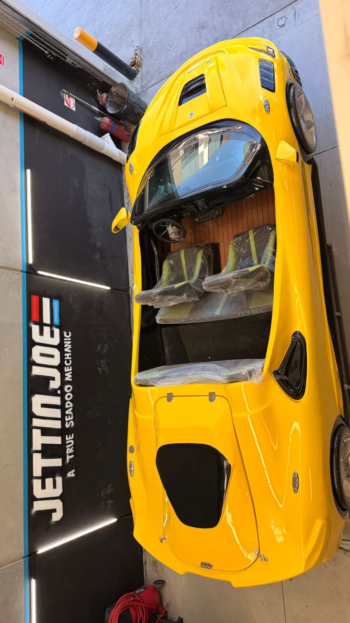 Cutaway engineering visualization of a high-performance marine jet powertrain, glowing electric blue energy lines, carbon fiber and machined aluminum, technical luxury, dramatic rim lighting, photorealistic, 8K